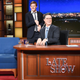 Illustration for article titled Stephen Colbert checks Lucas Hedges’ ID, pours him a drink, makes him sing Cats